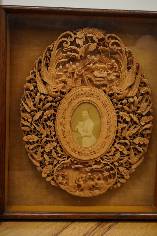 A pair of early 20th century, finely carved Chinese sandalwood photo frames, 30.5cmx24cm oval. Condition - good